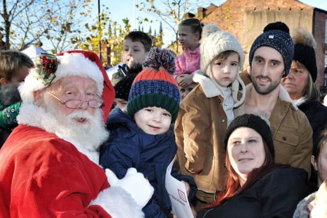 Father Christmas meets people gathered in Wigan town centre for the parade