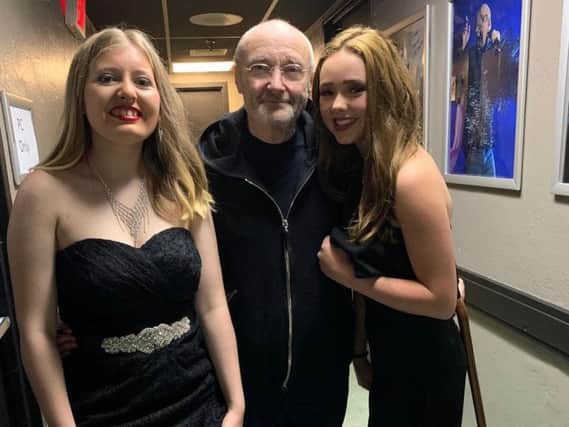 Emily Pearce (left) and Georgia Linde with Phil Collins