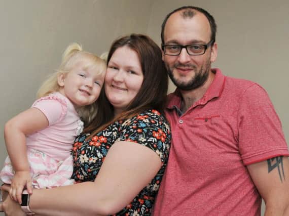 Three-year-old Evana Parksinon with parents Kayley and Scott Parkinson