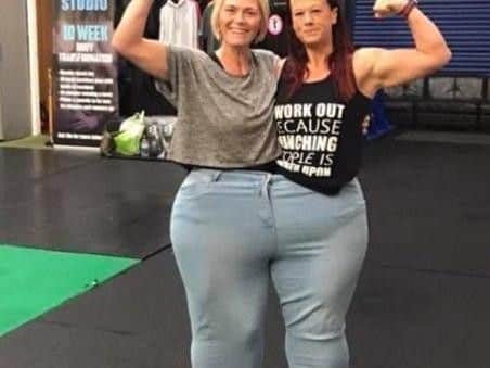 Kelly Tickle (right), who has lost 10 stone, with friend Laura Grundy who has lost six stone, both wearing Kellys old trousers