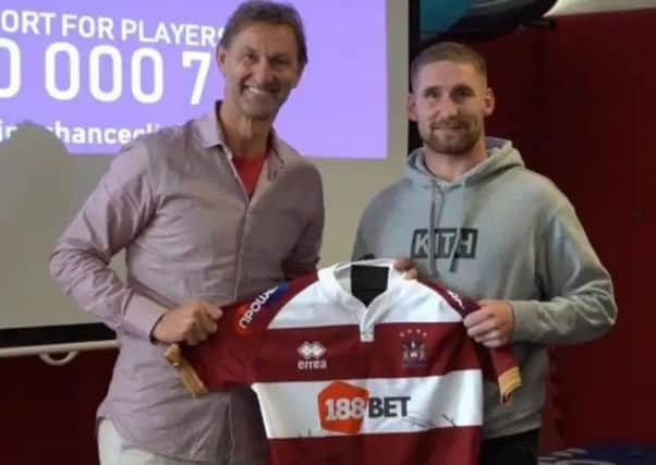 Tony Adams visited Wigan's training ground last season, and was presented with a Wigan shirt by Sam Tomkins