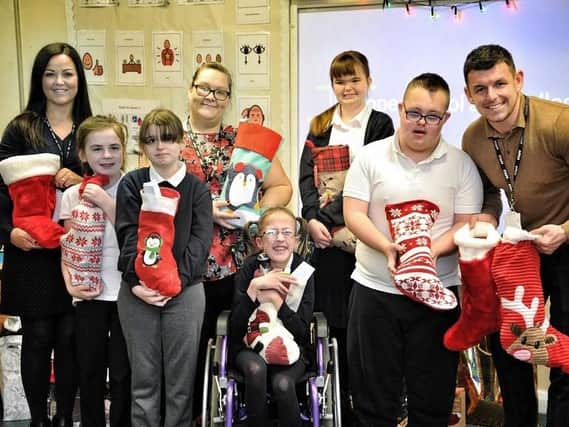 Staff and pupils with some of the stockings