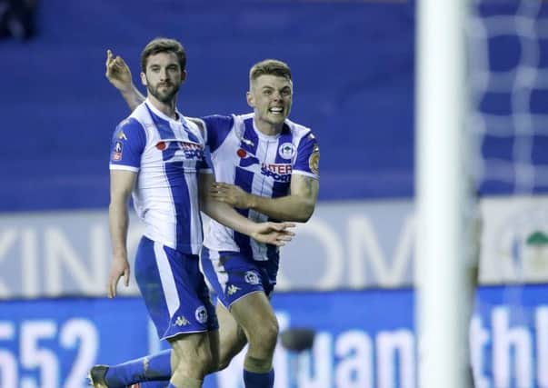 Max Power congratulates Will Grigg during their FA Cup win against Manchester City