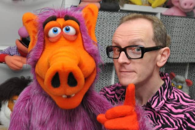 Phil Fletcher, puppeteer, puppet maker and the voice of CBBC puppet Hacker T Dog, with his collection of puppets in his workshop