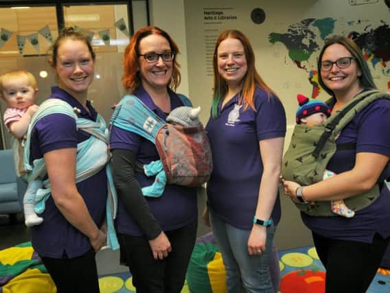Jess Hale with eight-month-old baby Riley, Sarah Holland, Rachael Cunliffe and Adele Pye, at the Sling Library, held every month at Wigan Library, Wigan Life Centre
