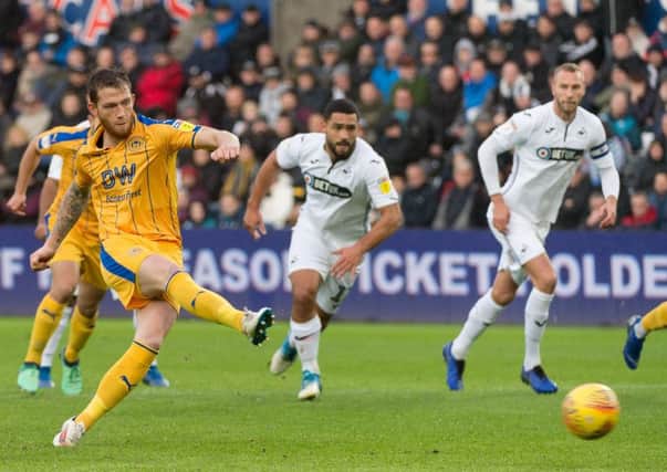 Joe Garner scores from the spot at Swansea