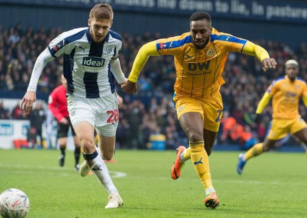 Chey Dunkley fights for the ball at West Brom