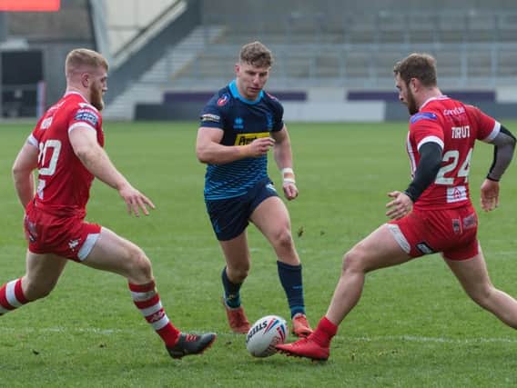 George Williams threads a kick through during Wigan's win over Salford