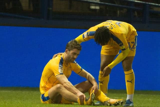 Will Grigg after damaging his ankle at Hillsborough