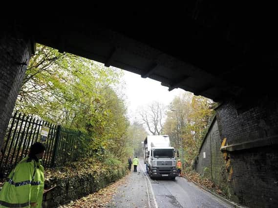 Police at the scene after a lorry struck the redundant span of the railway bridge on Rectory Lane, Standish. The resulting repairs caused major delays