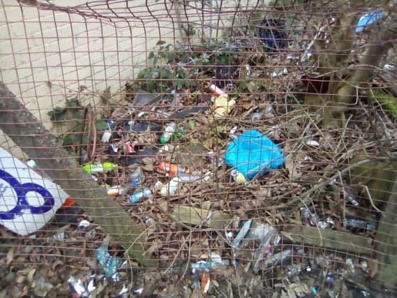 Rubbish in a fenced-off area on Liverpool Road