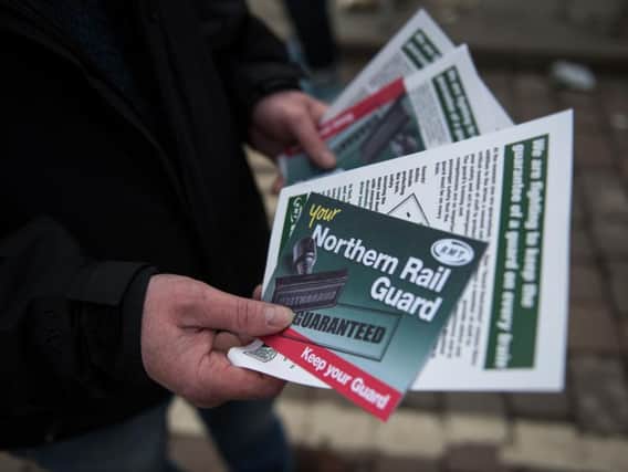 Members of rail staff taking industrial action hand out leaflets (Pic: OLI SCARFF/AFP/Getty Images)