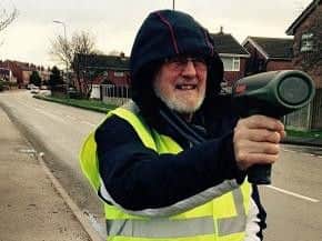 A resident in Bryn wielding a radar gun to check on speeding motorists