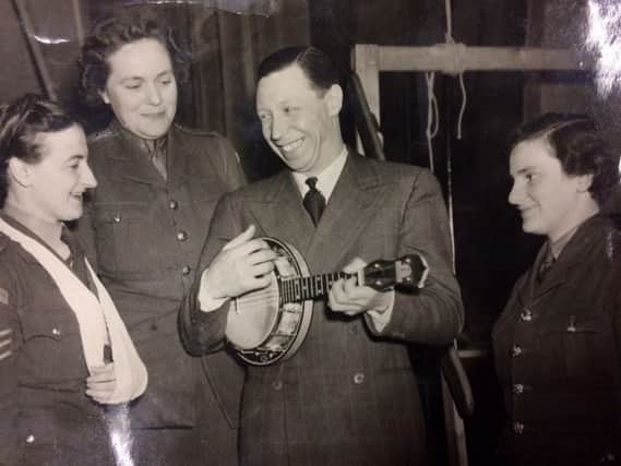 George Formby playing a banjolele