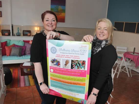 Kim Meehan and Lisa Morley, at Wellbeing Wigan CIC, celebrating the revamped cafe area