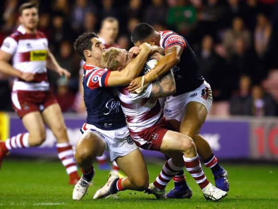Gabe Hamlin is tackled by the Sydney Roosters