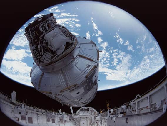 IMAX images from December 1998, show the crew of Space Shuttle Mission STS-88 beginning construction of the International Space Station