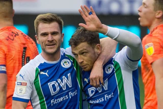 Joe Garner is congratulated by Callum McManaman