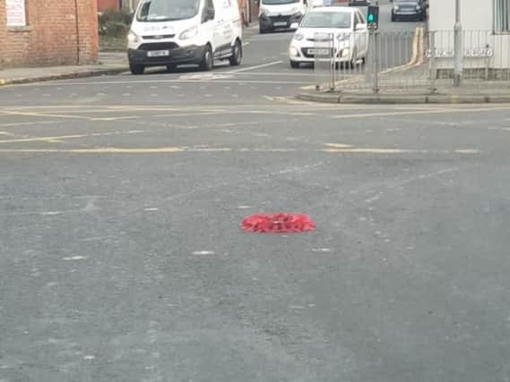 A wreath strewn in the road in Ince