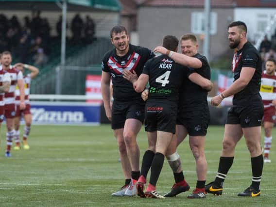 London Broncos players celebrate their win over Wigan on Sunday