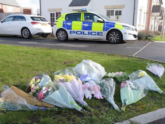 Flowers and soft toys have been placed on Fleming Court, Shevington, where police remain