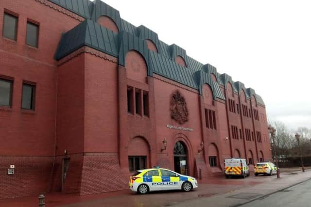 Police vehicles outside Wigan and Leigh Magistrates' Court on Wednesday morning