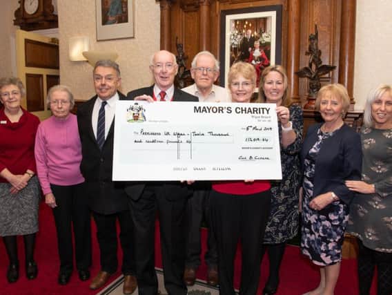 Members of the local Parkinsons UK group receive their money from former mayor and mayoress, Coun Bill and Joan Clarke