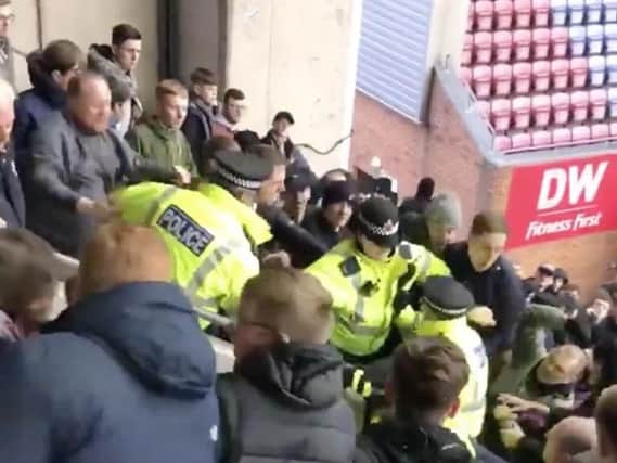 Fans clash with police at the DW Stadium. Footage by Reece Jones