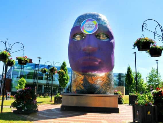 The Face of Wigan wrapped in purple for Autism Friends last summer