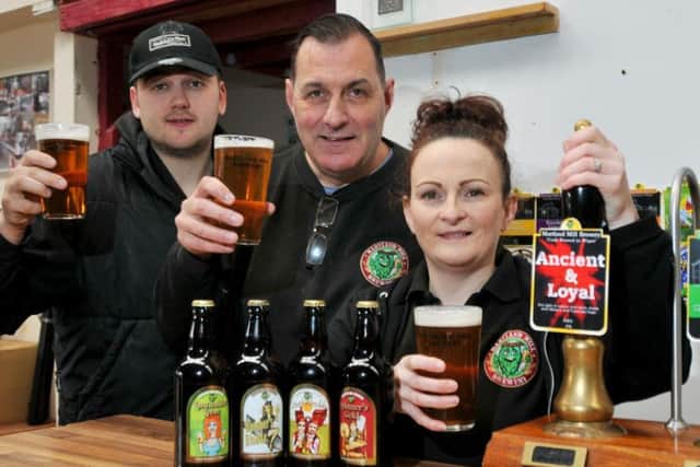 The team at Martland Mill Brewery, from left, head brewer Luke Blundell, Delia Wood and Paul Wood, as the real ale brewery is up for sale. Pictured with their final ale, Ancient and Loyal and, below, a pint of their finest