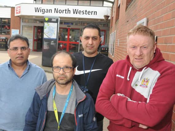 Taxi drivers, from left, Abrar Ahmed, Mike Goksuacik, Ramon Hossinjani and Ian Rogers, representative of Wigan North Western RMT (union of Rail, Maritime and Transport workers)