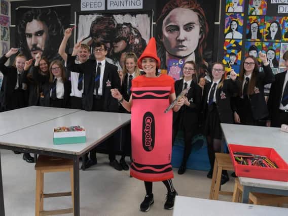 Belinda Neild gets encouragement from her pupils as she prepares for the London marathon dressed as a crayon