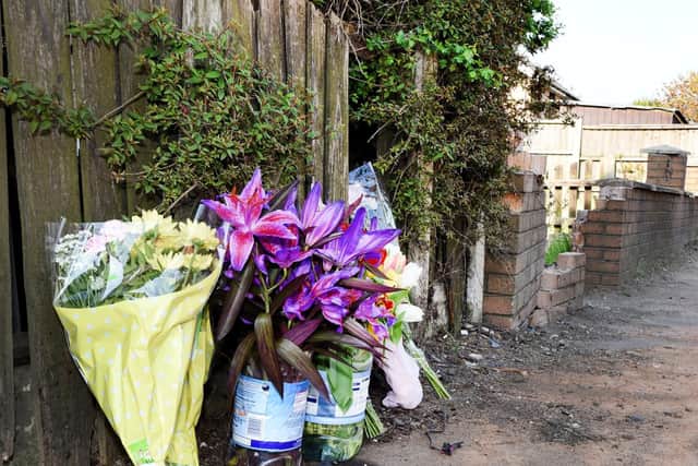 Flowers laid at the scene in Bickershaw Lane