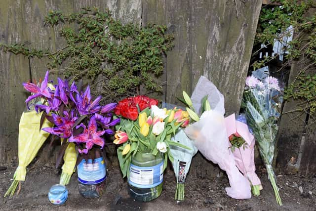 Flowers laid at the scene in Bickershaw Lane