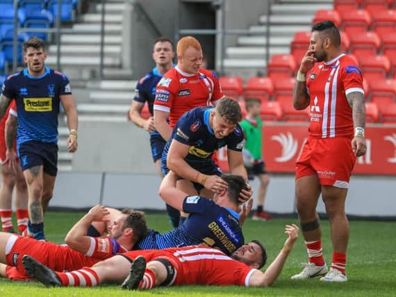 Joe Greenwood is congratulated on his try against Salford