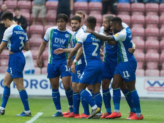 Latics players celebrate as they secure their Championship status for next season