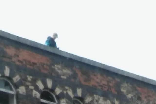 A trespasser photographed on the roof of the building