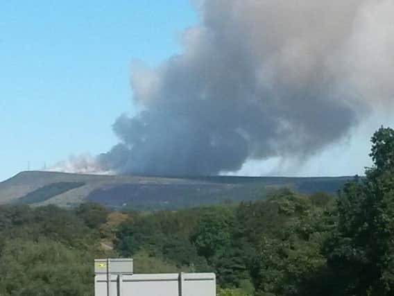 The huge plume of smoke rises over Rivington Moor during the height of the fire in June last year