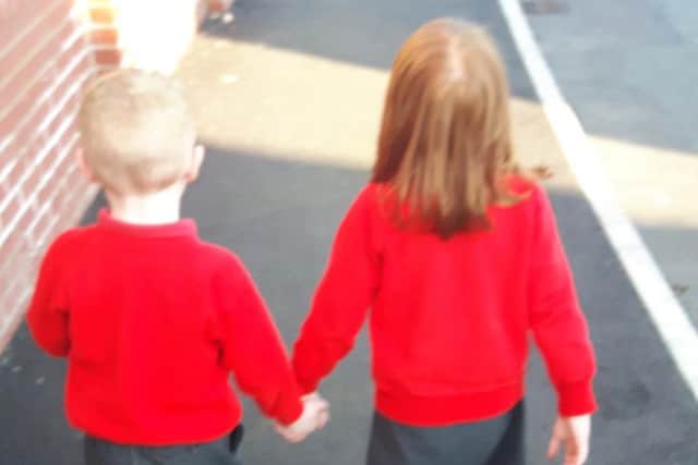 Inseparable: Andrew holds hands with one of his close friends on their way home from nursery, but won't get to go to Reception together