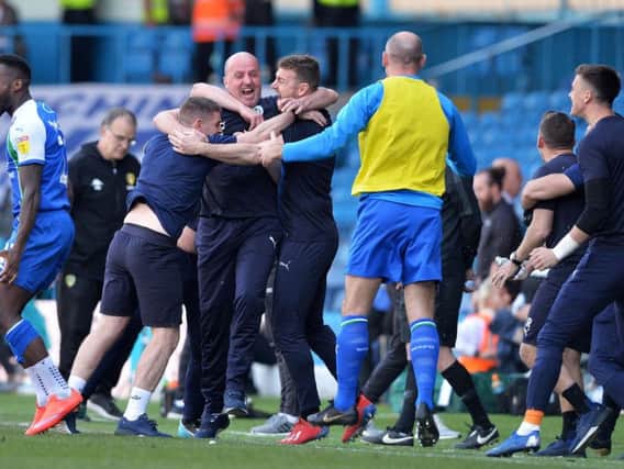 Paul Cook and his backroom staff celebrate at Leeds