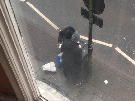 People using drugs on top of a bin on Mesnes Street in broad daylight