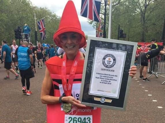 Belinda Neild with her certificate at the London Marathon finish line