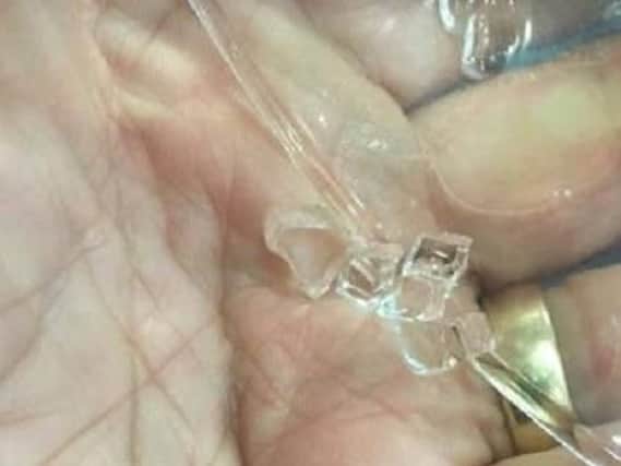 The pieces of glass found in the drink