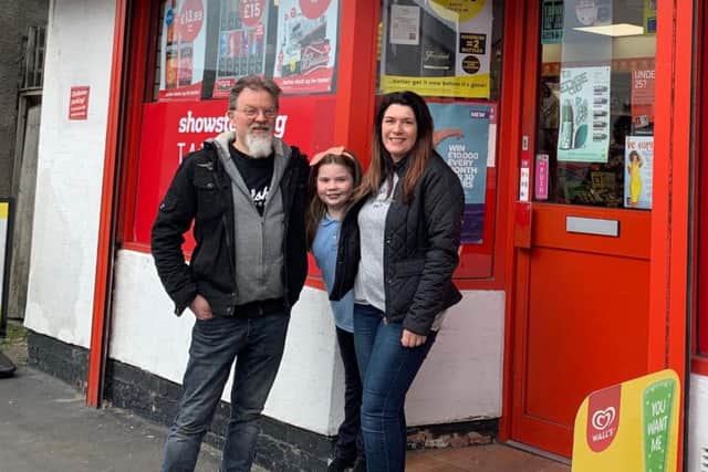 The Hammonds outside their shop