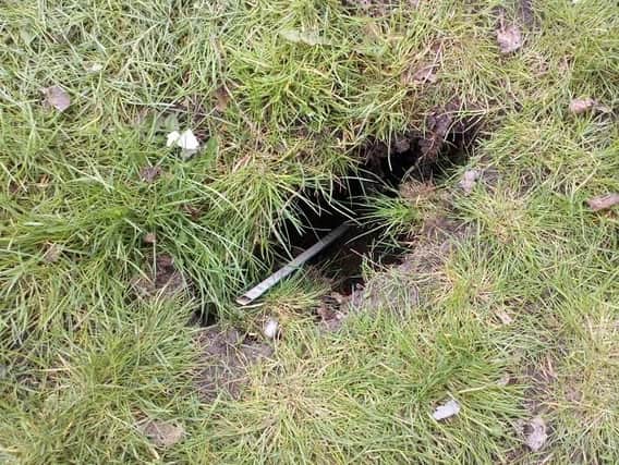 The sink hole in a verge on Scot Lane, Wigan