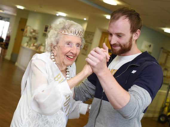 Flora May Choraffa, known as May, celebrates her 100th birthday with exercise instructor Ryan Cadman at Belong Village, Platt Bridge