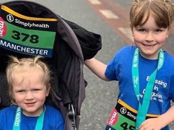 Evana Parkinson, four, with big sister Erica, five, at the Great Manchester Run