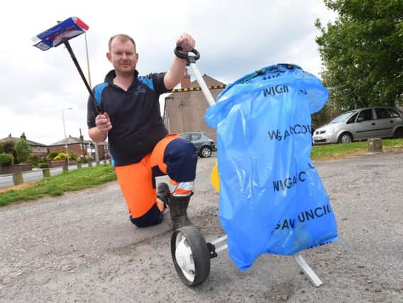 James Palmer with the cart made of recycled materials he is using to clean up Hindley Green