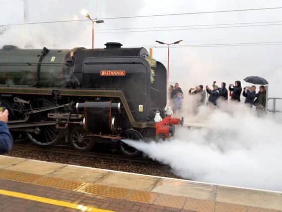 The locomotive letting off steam in Wigan
