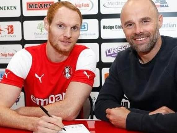 Shaun MacDonald signs for Rotherham, watched by former Latics striker Paul Warne (Pic: Rotherham United)